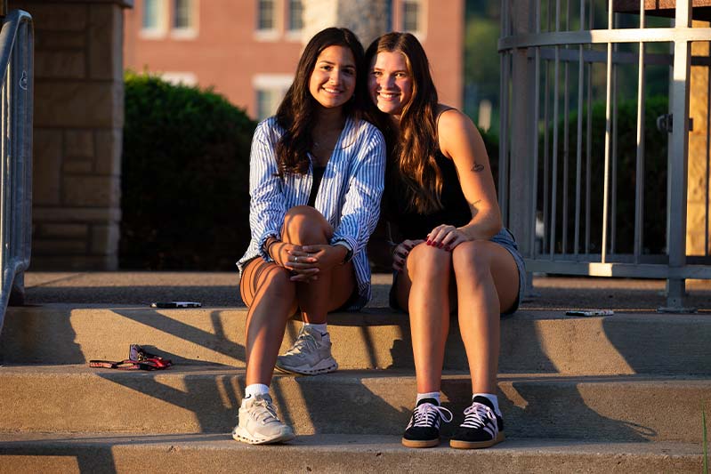 students sitting on a step