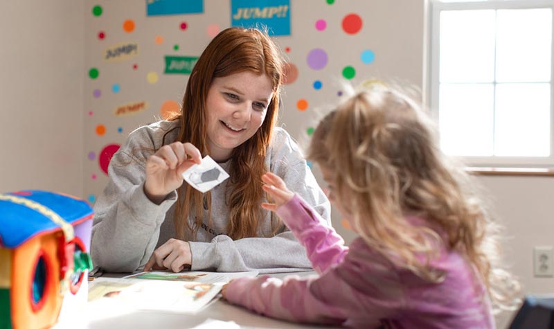 a student teacher helping a child