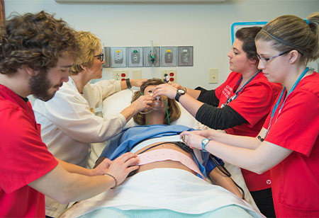 Nursing students practicing in a lab