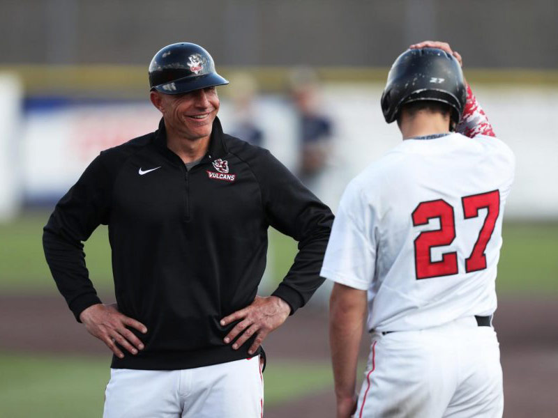 California's baseball coach standing with a player
