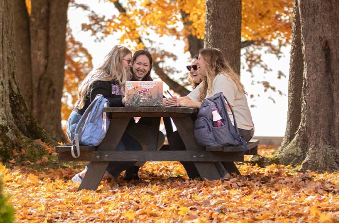 Students sitting on a picnic table