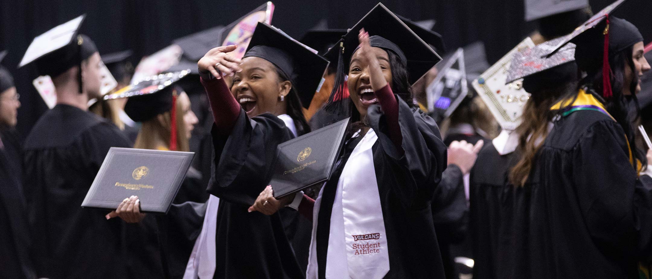 Students rejoicing over their graduation accomplishment