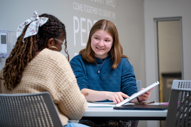 A peer mentor guides a student on how to set a study schedule
