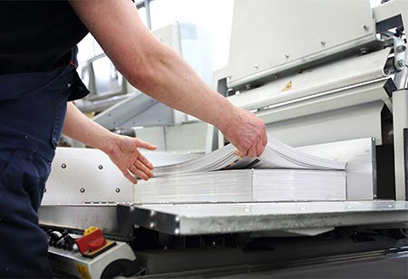 An employee gathering print materials