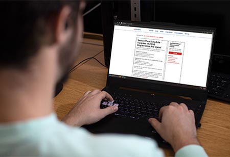 A student browsing the internet on a laptop