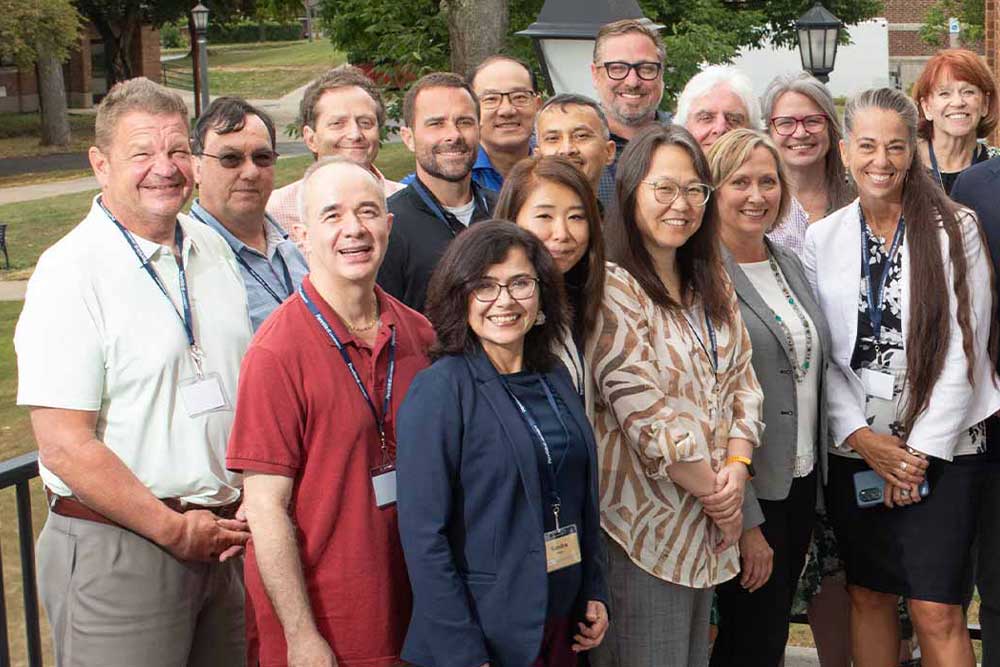 faculty members posing for a group photo at a conference