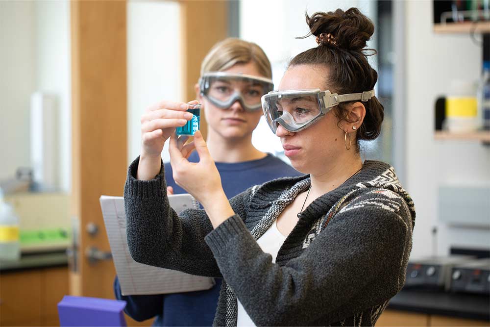 PennWest student photographs textile production equipment during a hands-on research and creative project that applies classroom learning to real-world experiences.