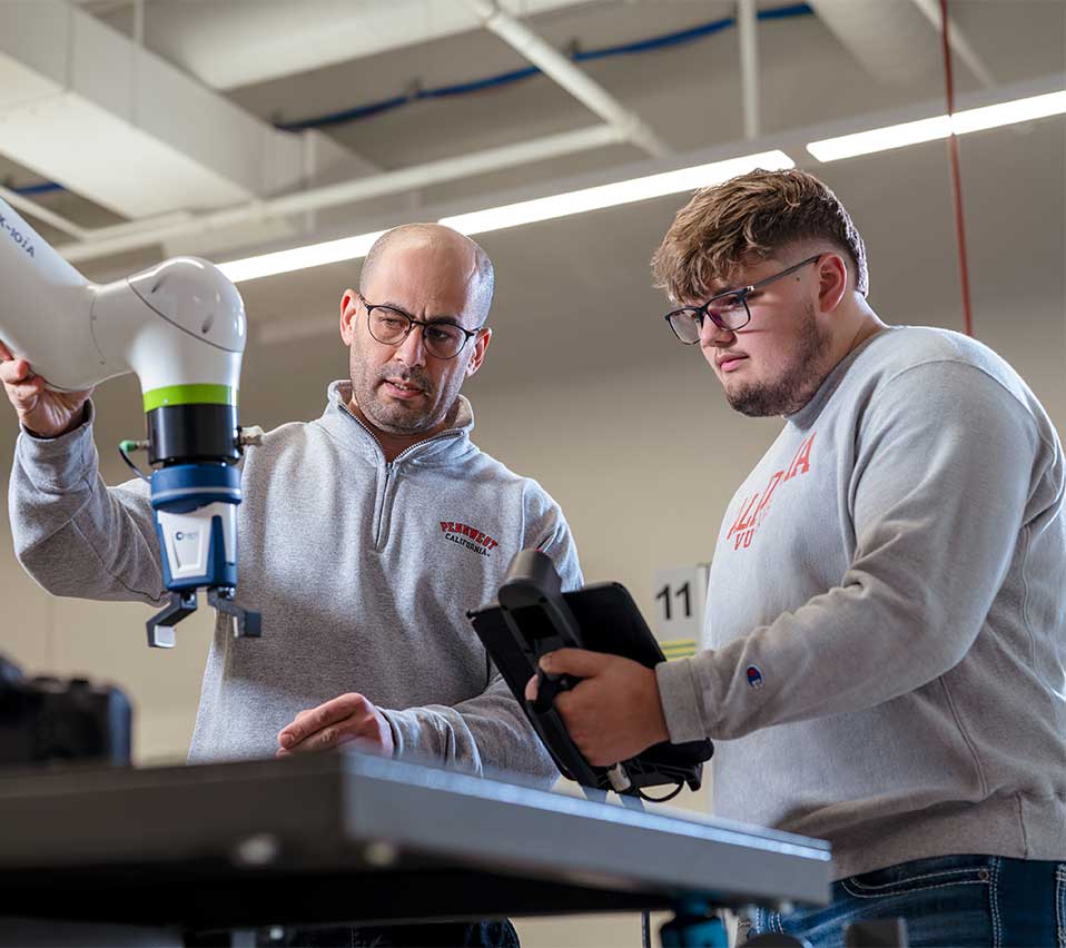 Branden Gmutza working with a PennWest professor in an engineering lab