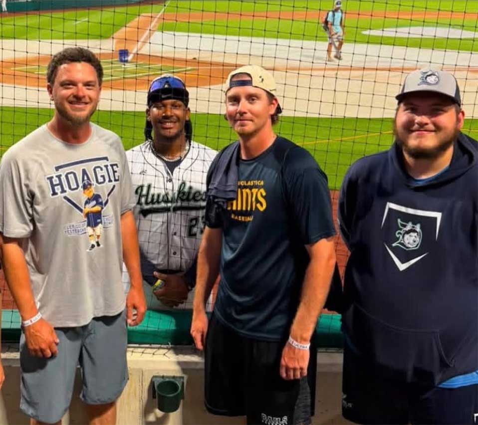 PennWest Clarion student James O'Dell (far right), clubhouse manager for the Duluth Huskies, poses with (from left) Assistant Coach Jake Pashby, Head Coach Marcus Pointer, Huskies athlete Jalen Smith and Assistant Coach Jake Lewis at the Field of Dreams movie site in Dyersville, Iowa, during the Northwoods League All-Star Game.