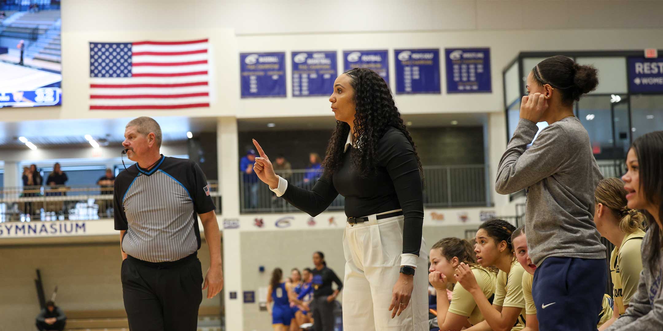 A basketball coach instructing the team