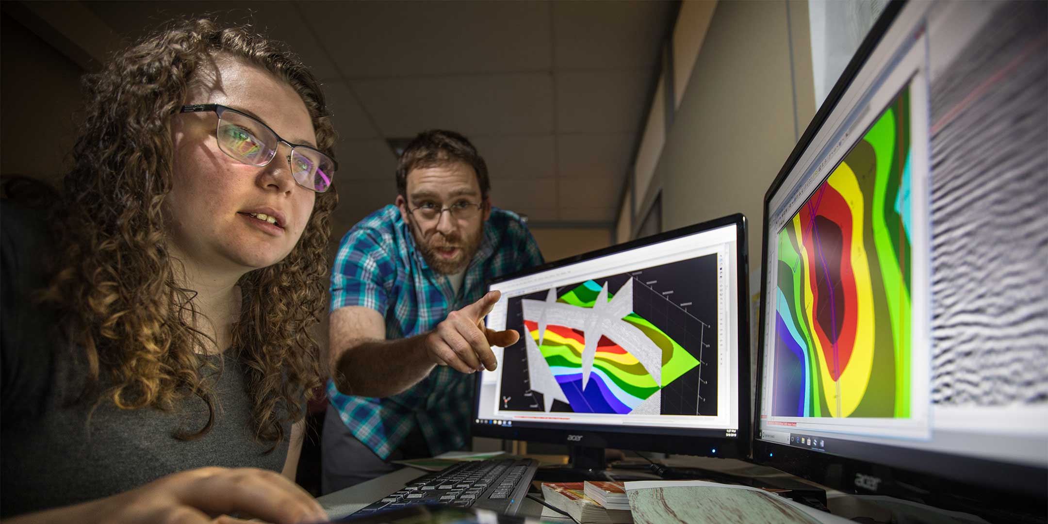a geotechnical applications student reviewing geological information on a computer