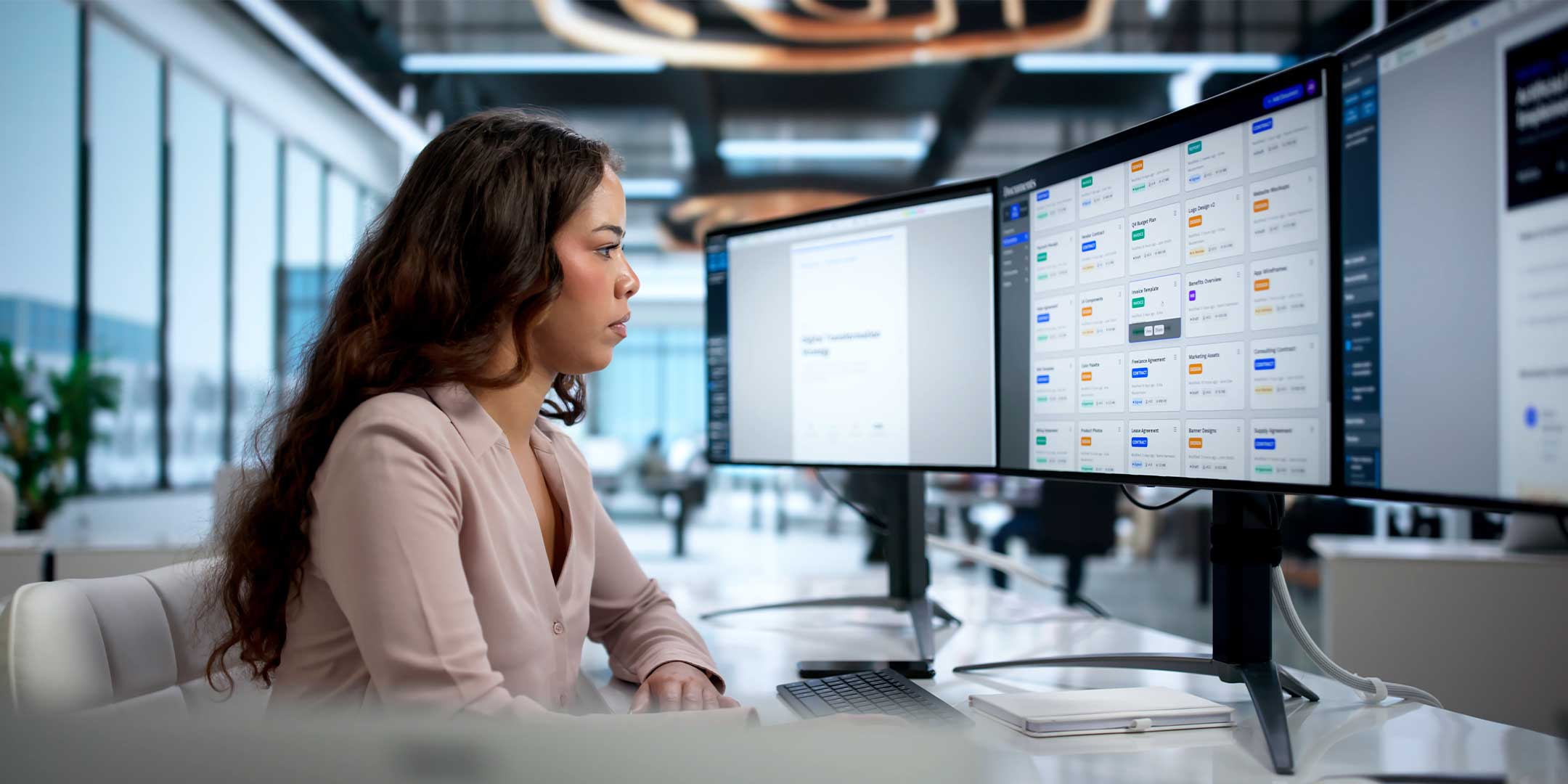 an information science student analyzing data on multiple computer screens
