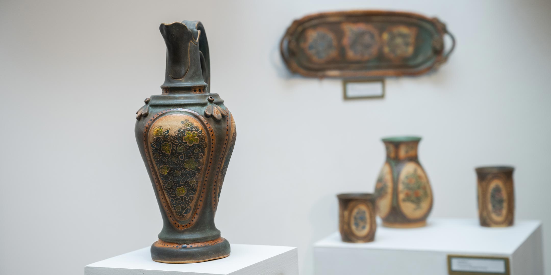 an image of multiple art pieces on display at an art gallery