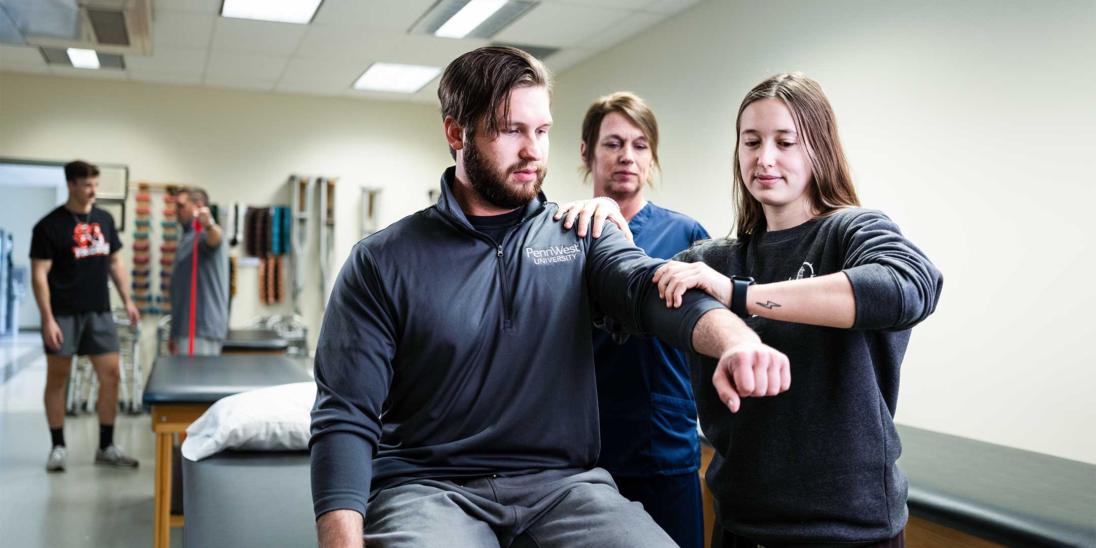 pre-athletic training students examining an athlete