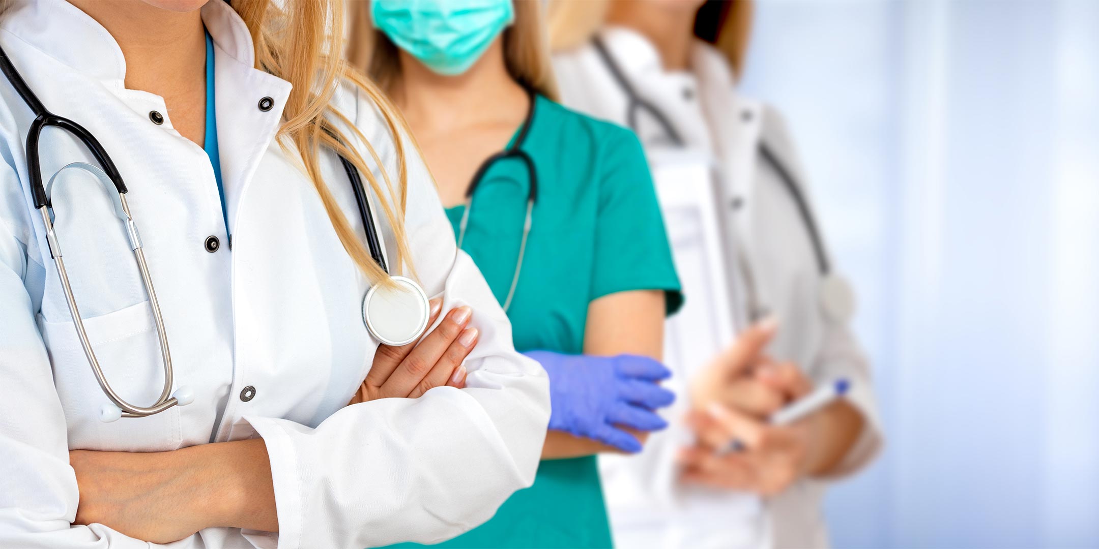 three doctors standing with their arms crossed