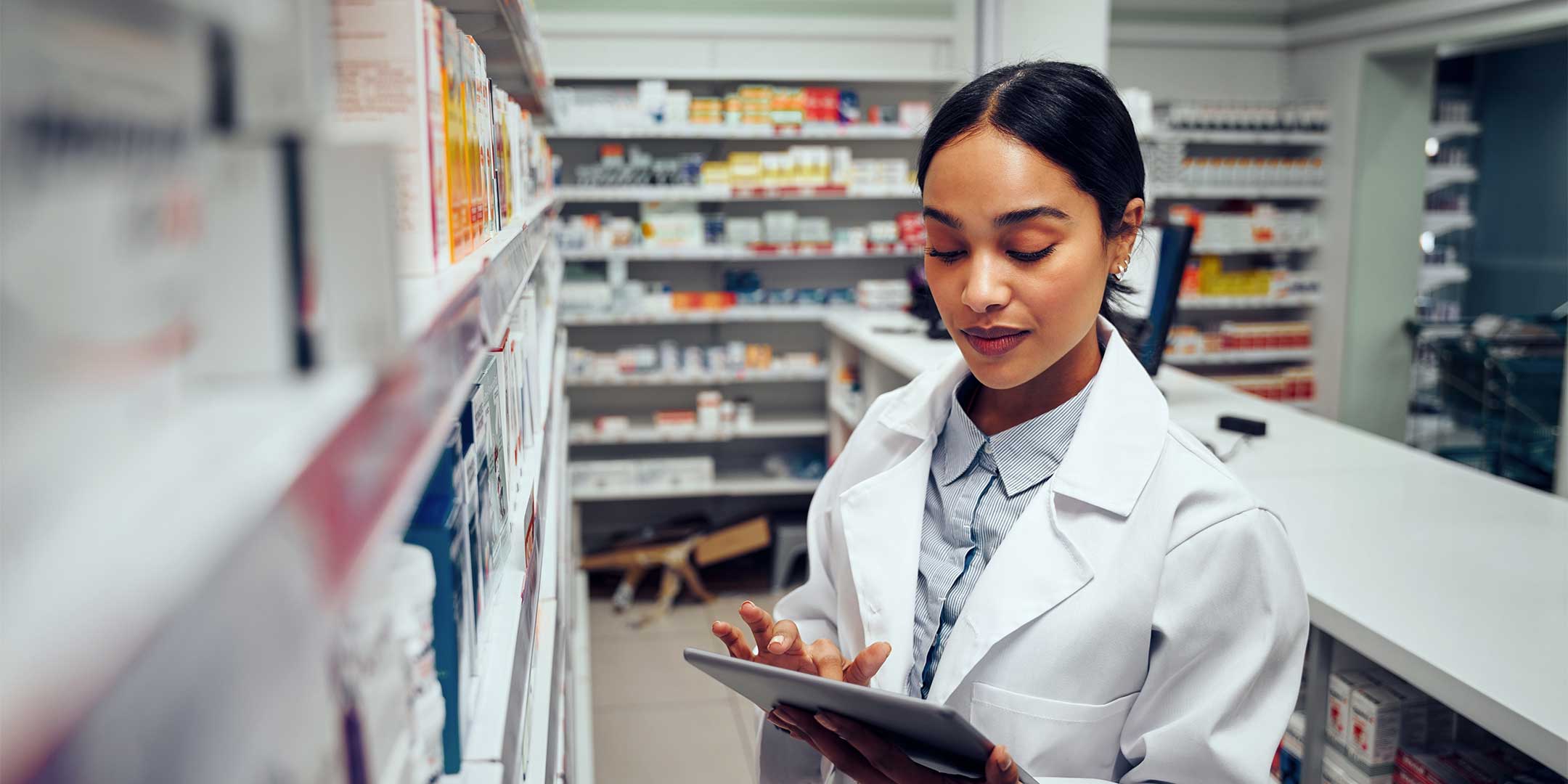 a pharmacist checking shelf inventory