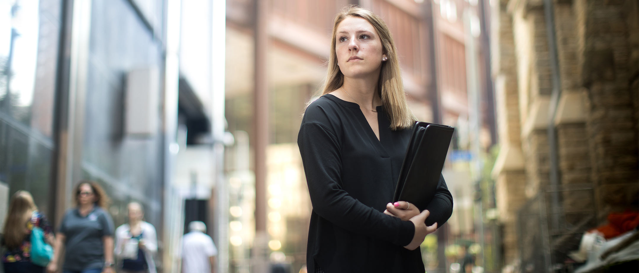 A salesperson standing on the sidewalk