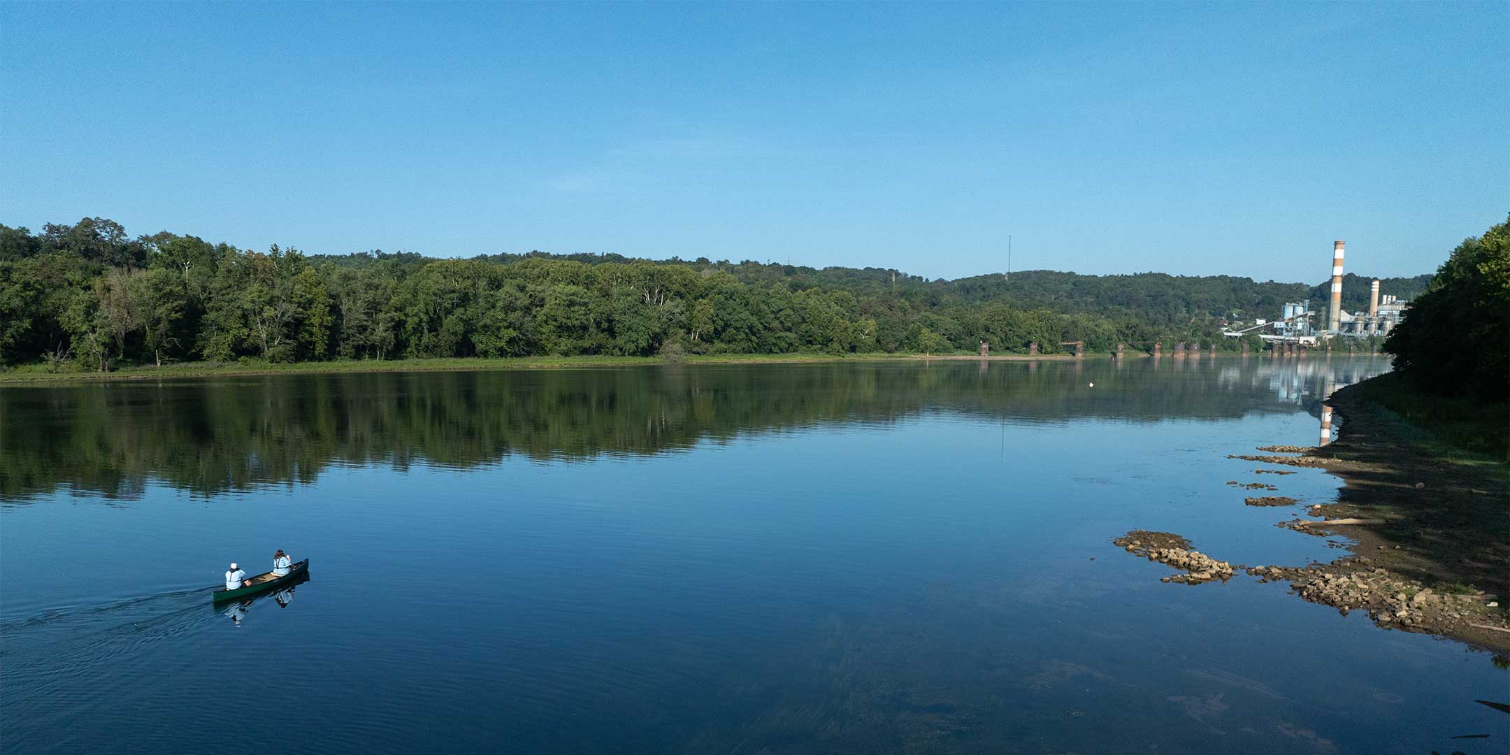 a scenic view of a kayak on a river