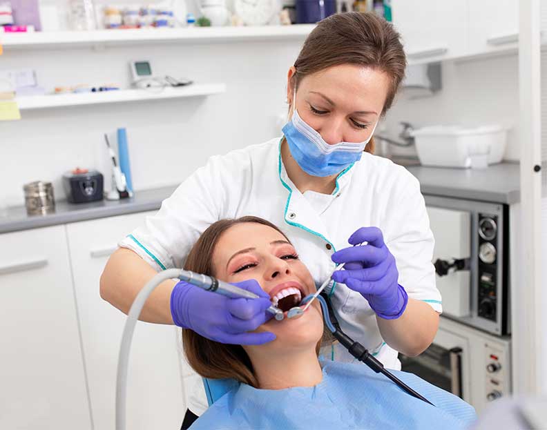 a dentist examining a patient's teeth