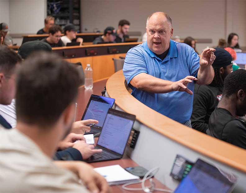 a finance professor teaching a classroom of students