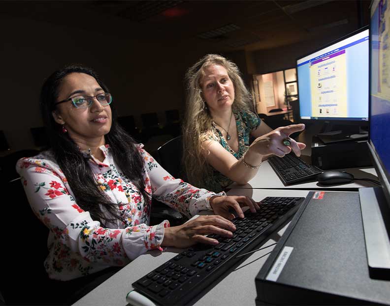 two information science professors examining crypography data