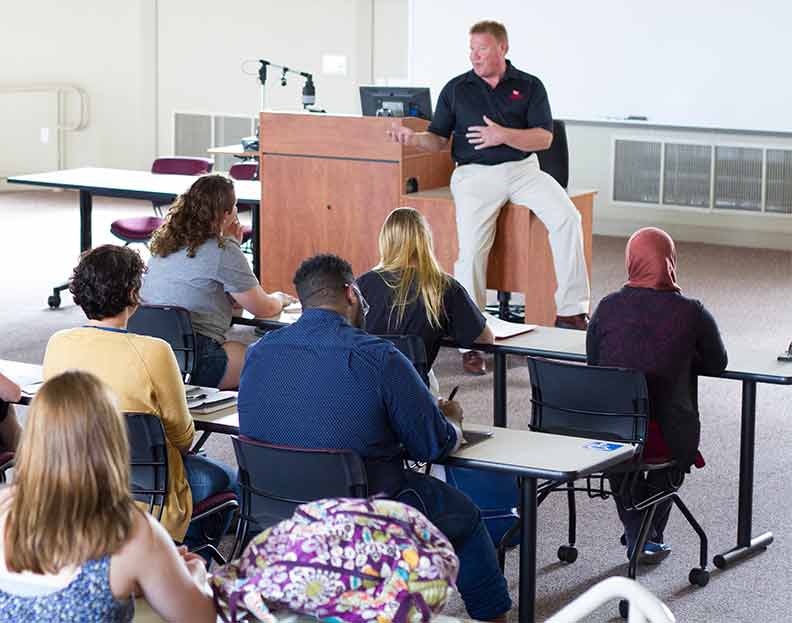students listening to a professor in a lecture hall