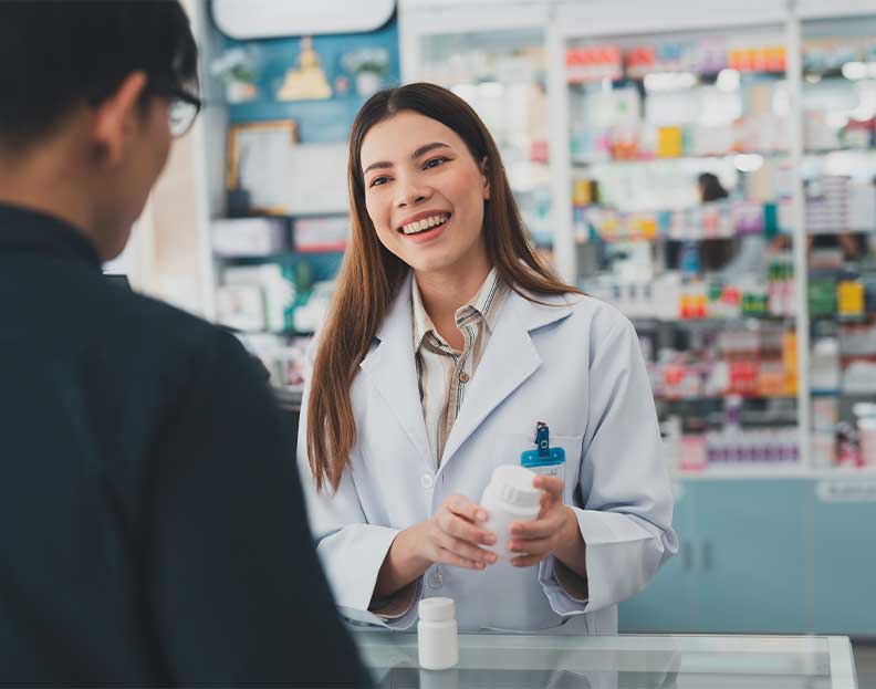 a pharmacist reviewing a prescription with a customer