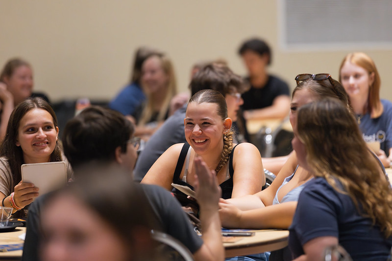 Admitted PennWest students sitting around a table playing a game