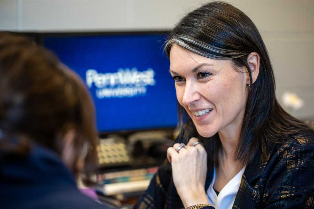 A PennWest counselor helping a dual enrollment student