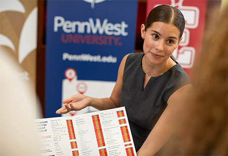 An admissions counselor at a recruiting event
