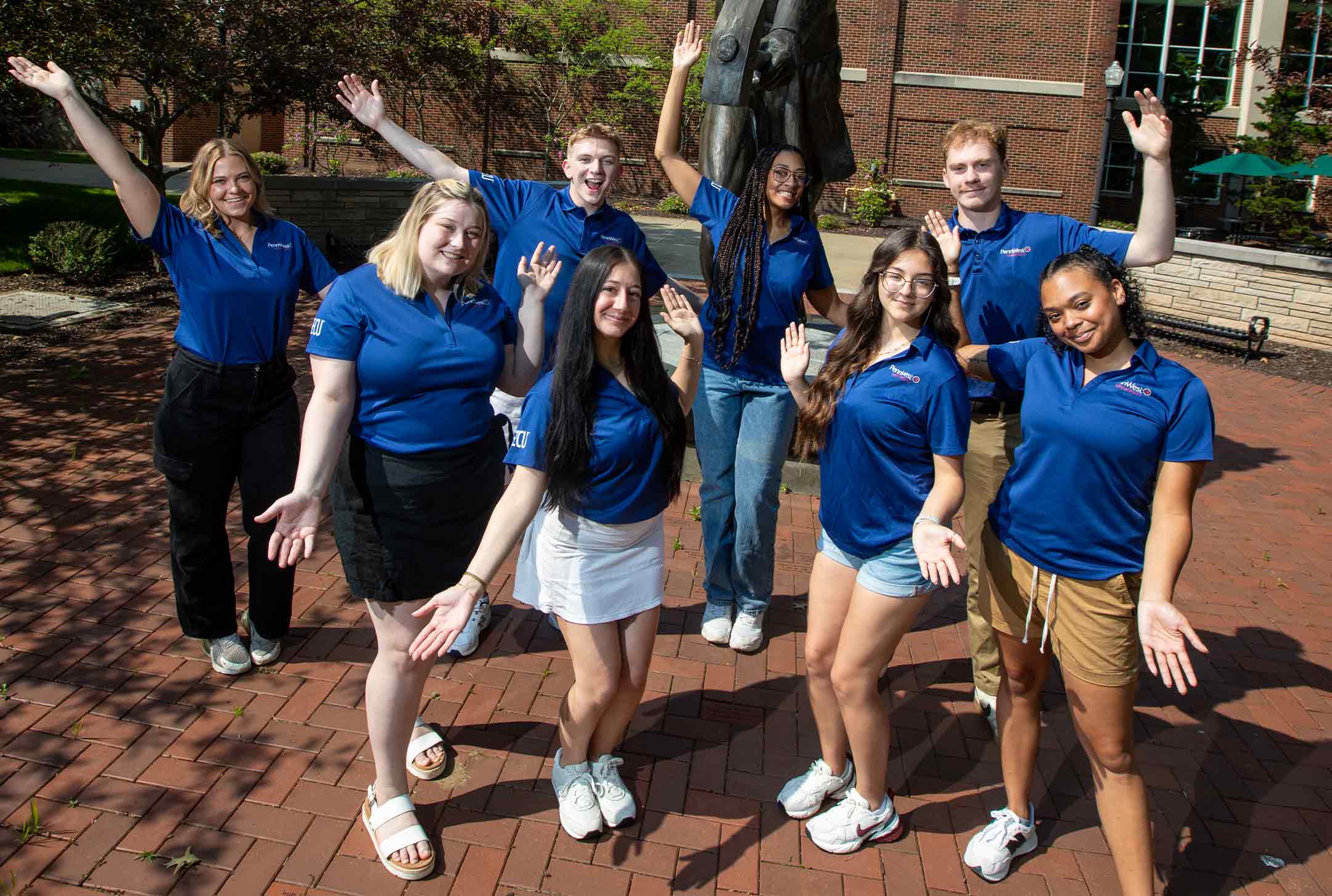 students raising their arms in the air