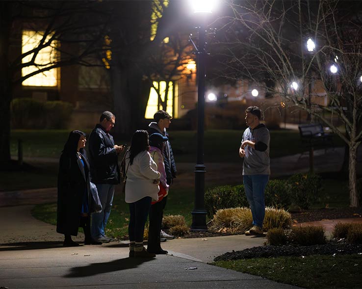 Students walking on campus during a twilight tour