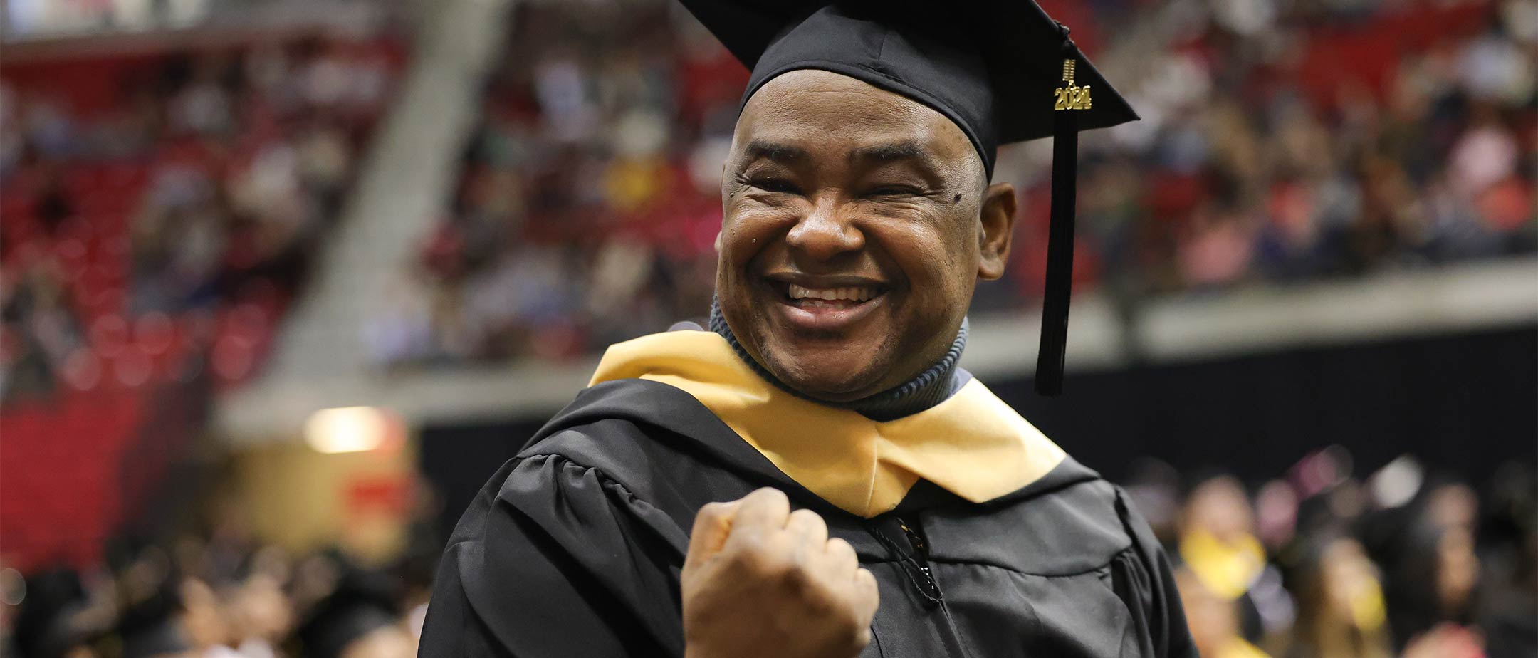 A grad student receiving their hood at graduation