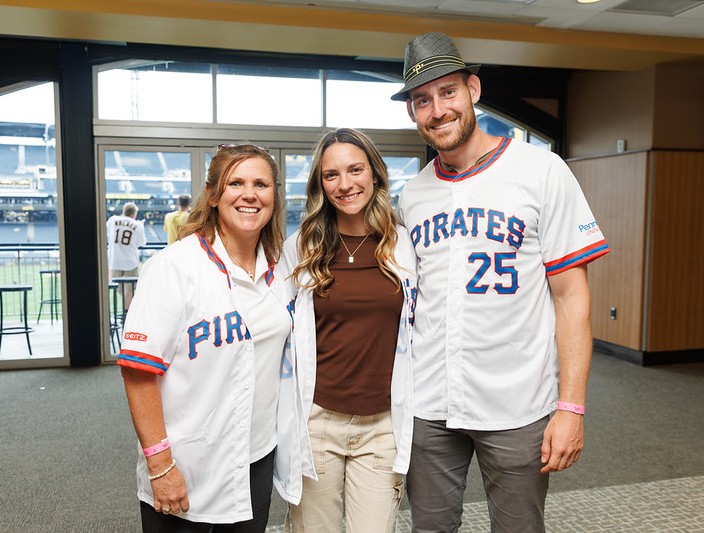 Three alumni pose at the Pittsburgh Pirate alumni event