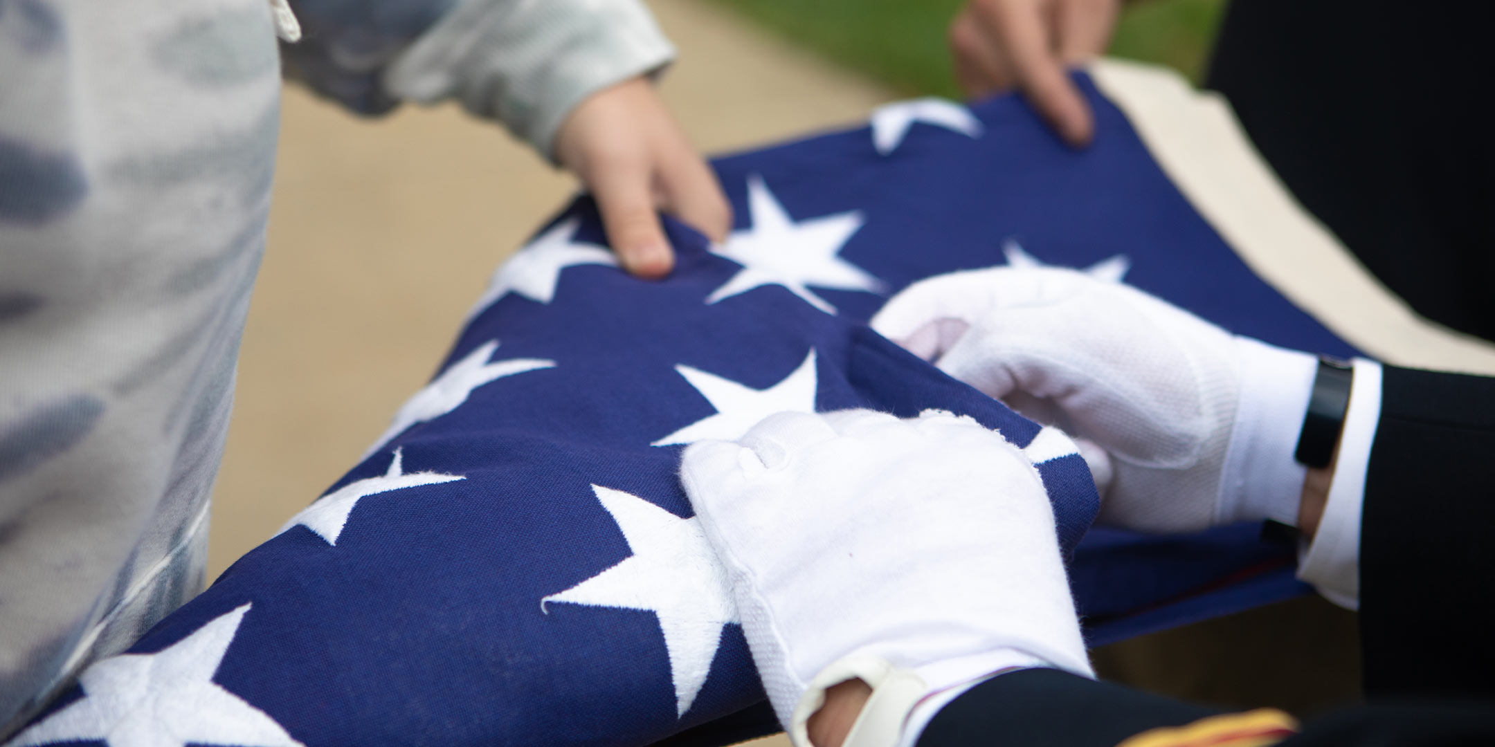 military students folding the American flag