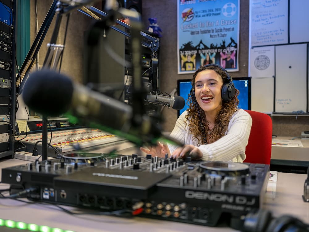 PennWest student using radio station controls. 
