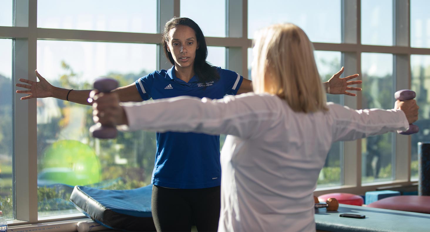 A exercise science student working with a client