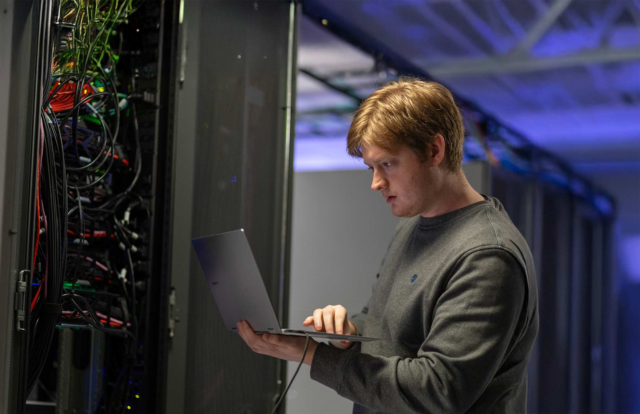 A man testing servers in an IT department.