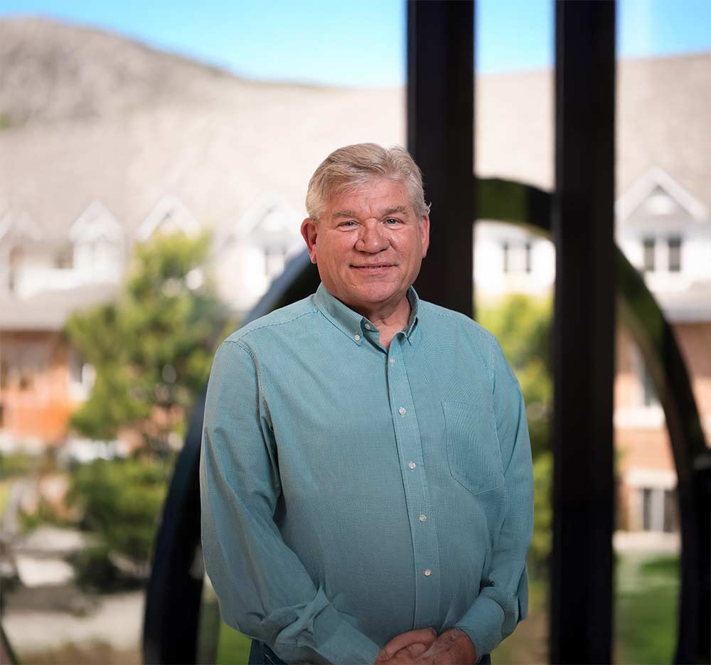 PennWest graduate student working on laptop