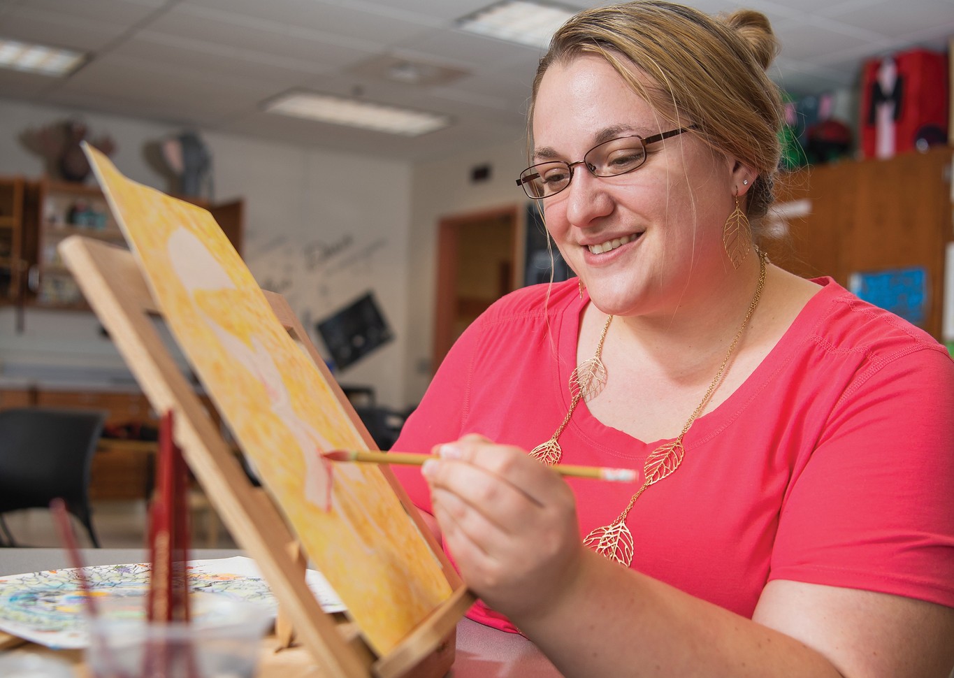 woman paints a picture for art theraphy