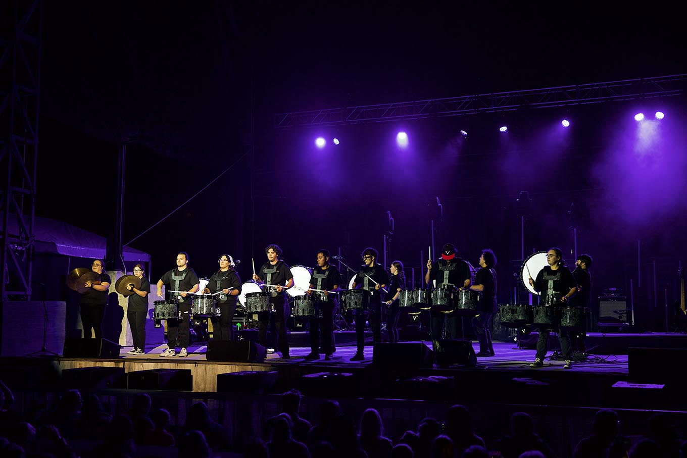 members of the california drumline with instruments on stage