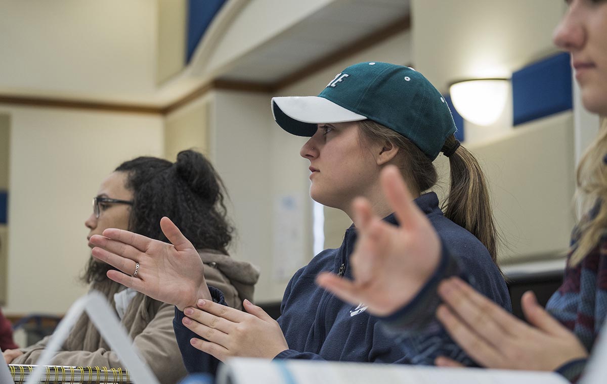 student in deaf education class learning signs