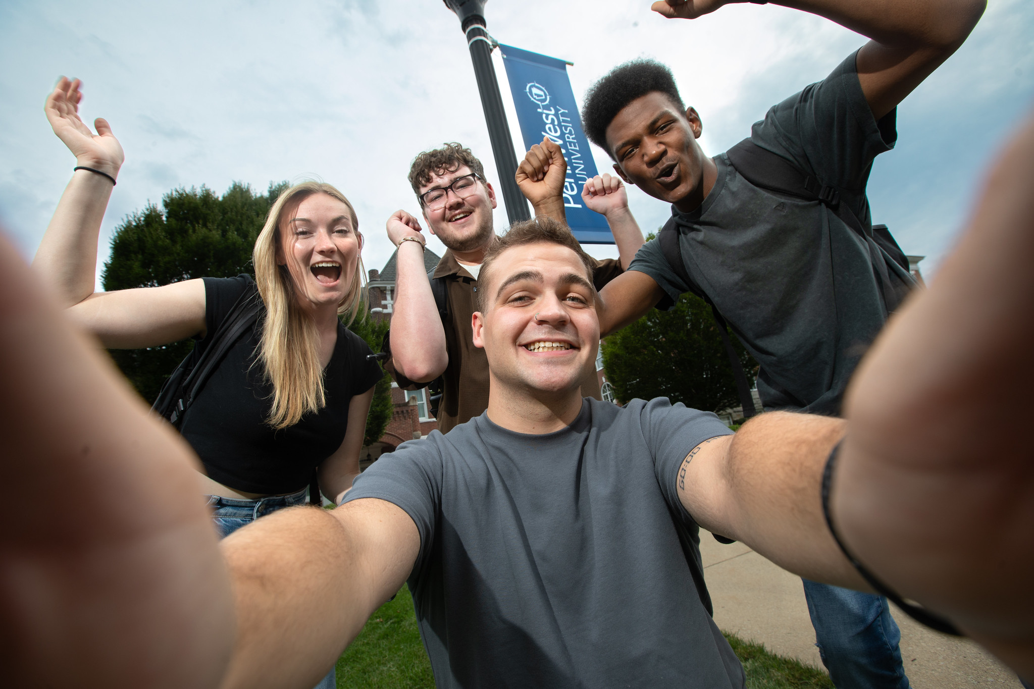 group of students take a selfie on campus