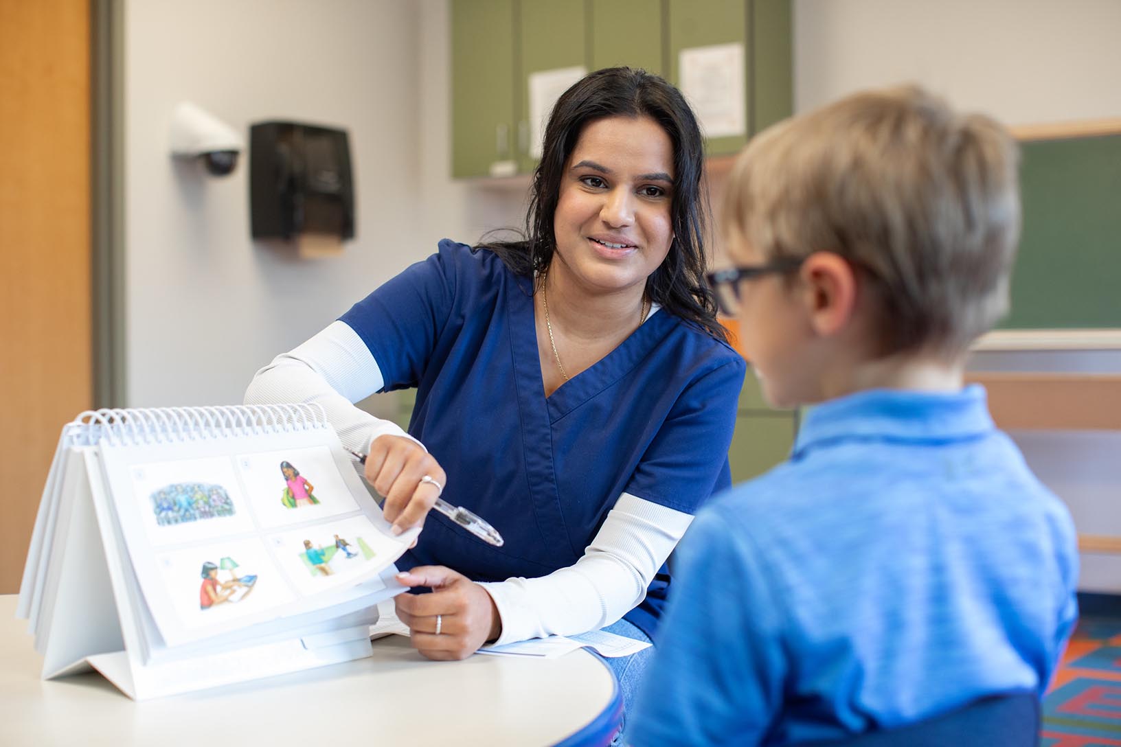 student works with child at speech clinic