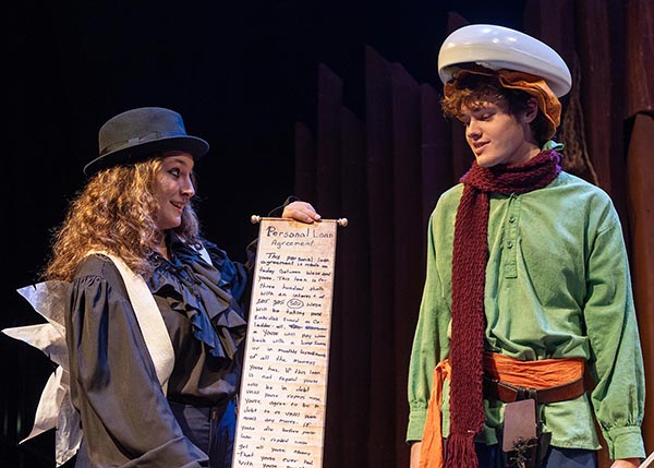two students in a scene from the play