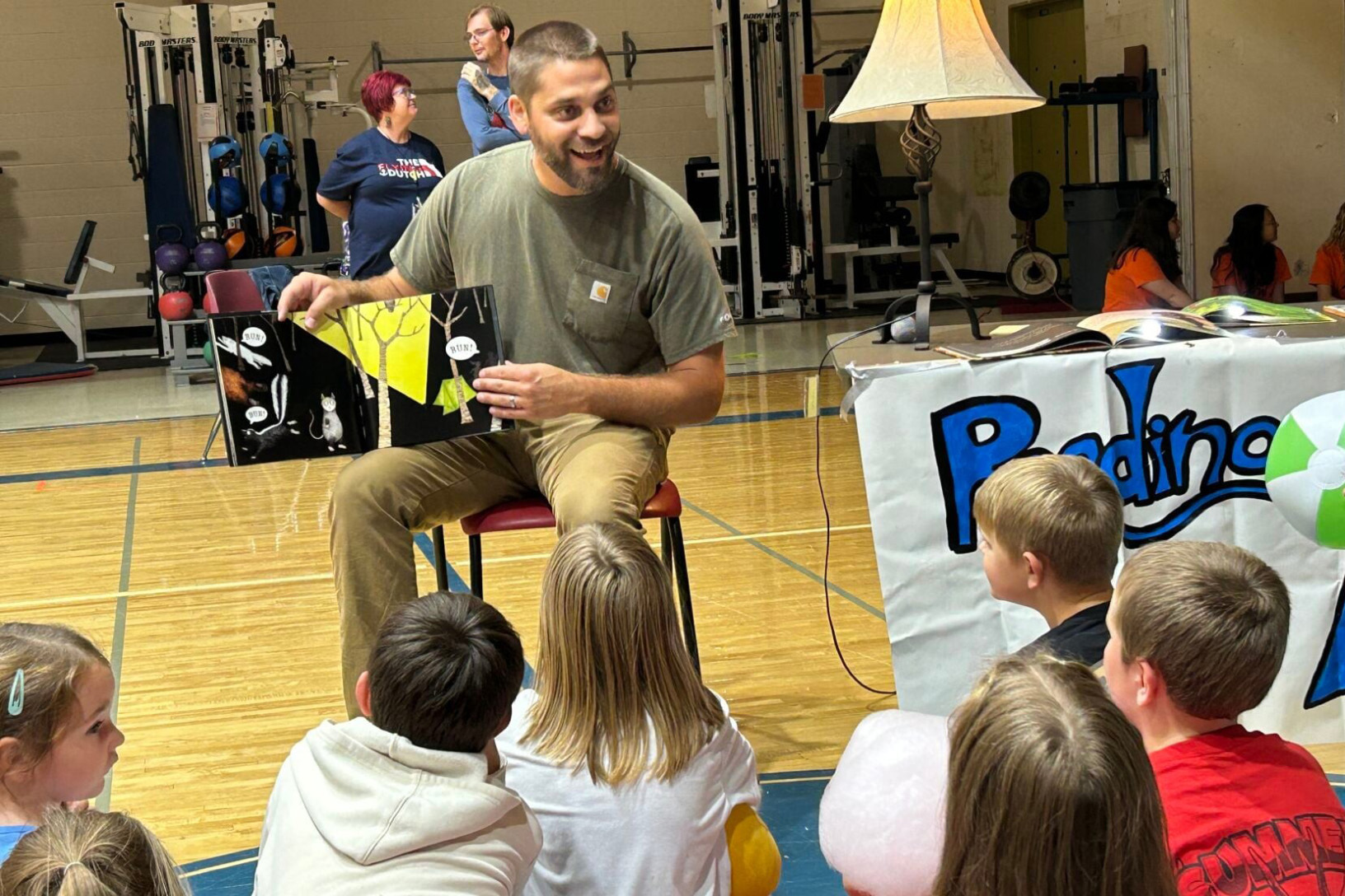 PennWest California alumnus Jacob Pistner reads to children. 