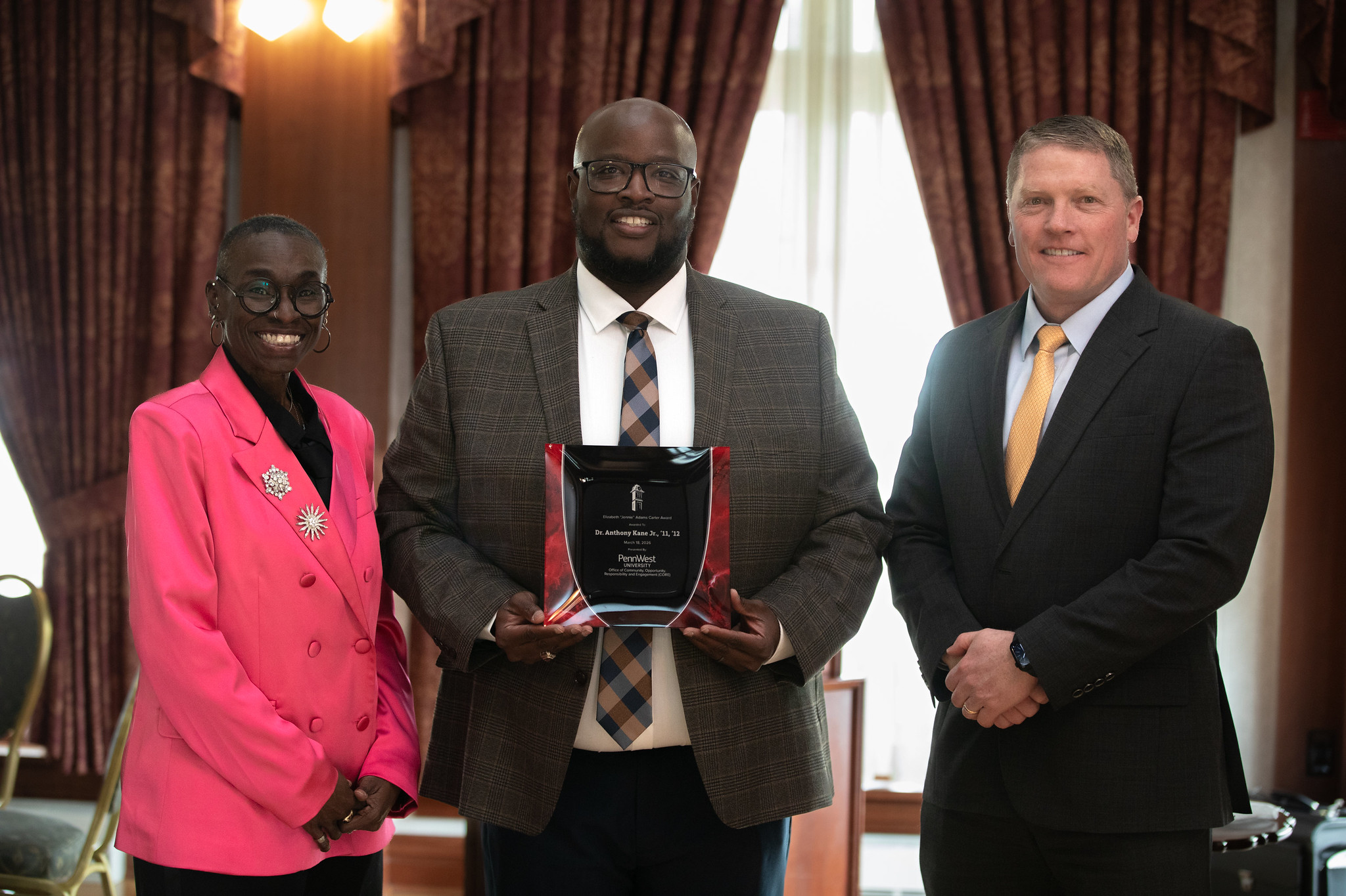 three people pose with jennie carter award