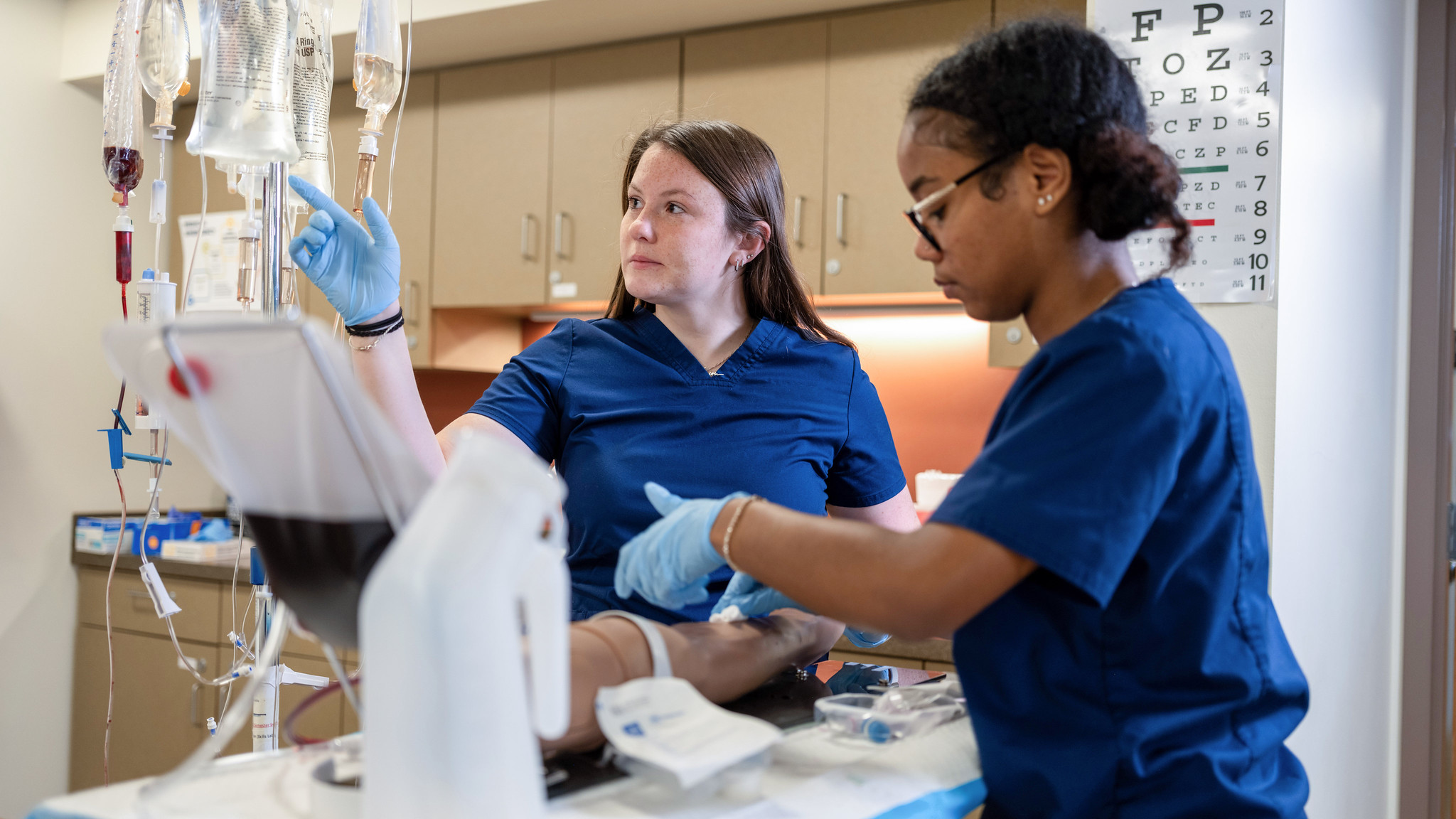 two students work in a medical setting