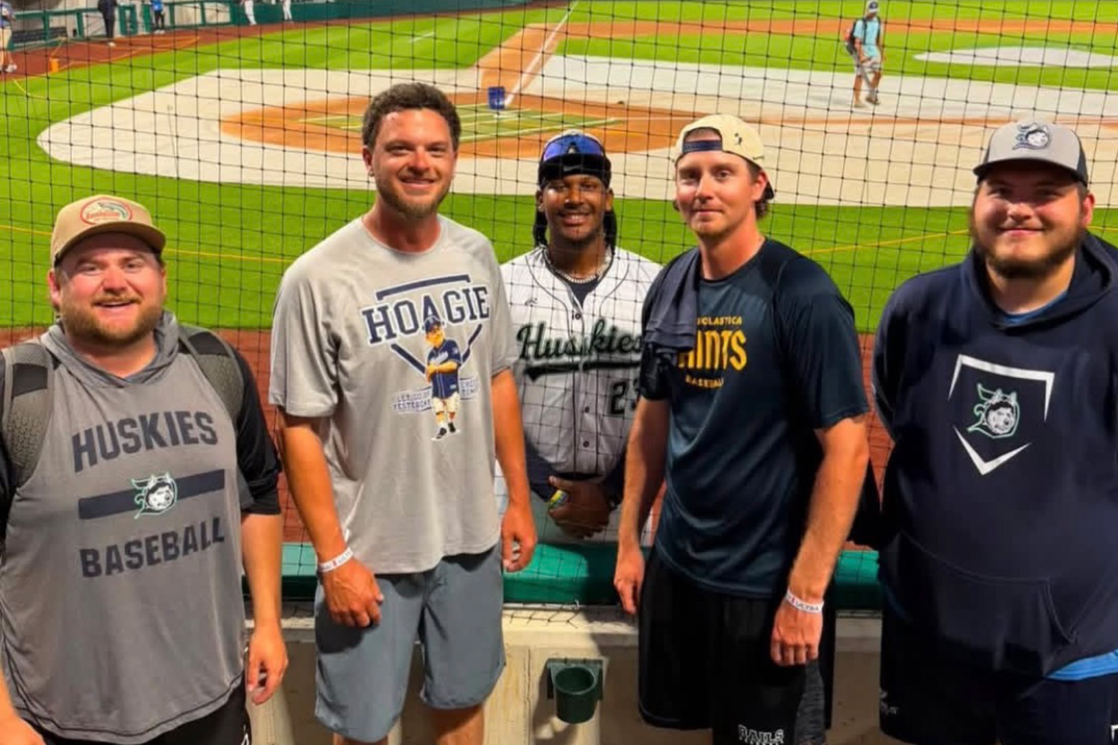 PennWest Clarion student James O'Dell (far right), clubhouse manager for the Duluth Huskies, poses with (from left) Assistant Coach Jake Pashby, Head Coach Marcus Pointer, Huskies athlete Jalen Smith and Assistant Coach Jake Lewis at the Field of Dreams movie site in Dyersville, Iowa, during the Northwoods League All-Star Game.