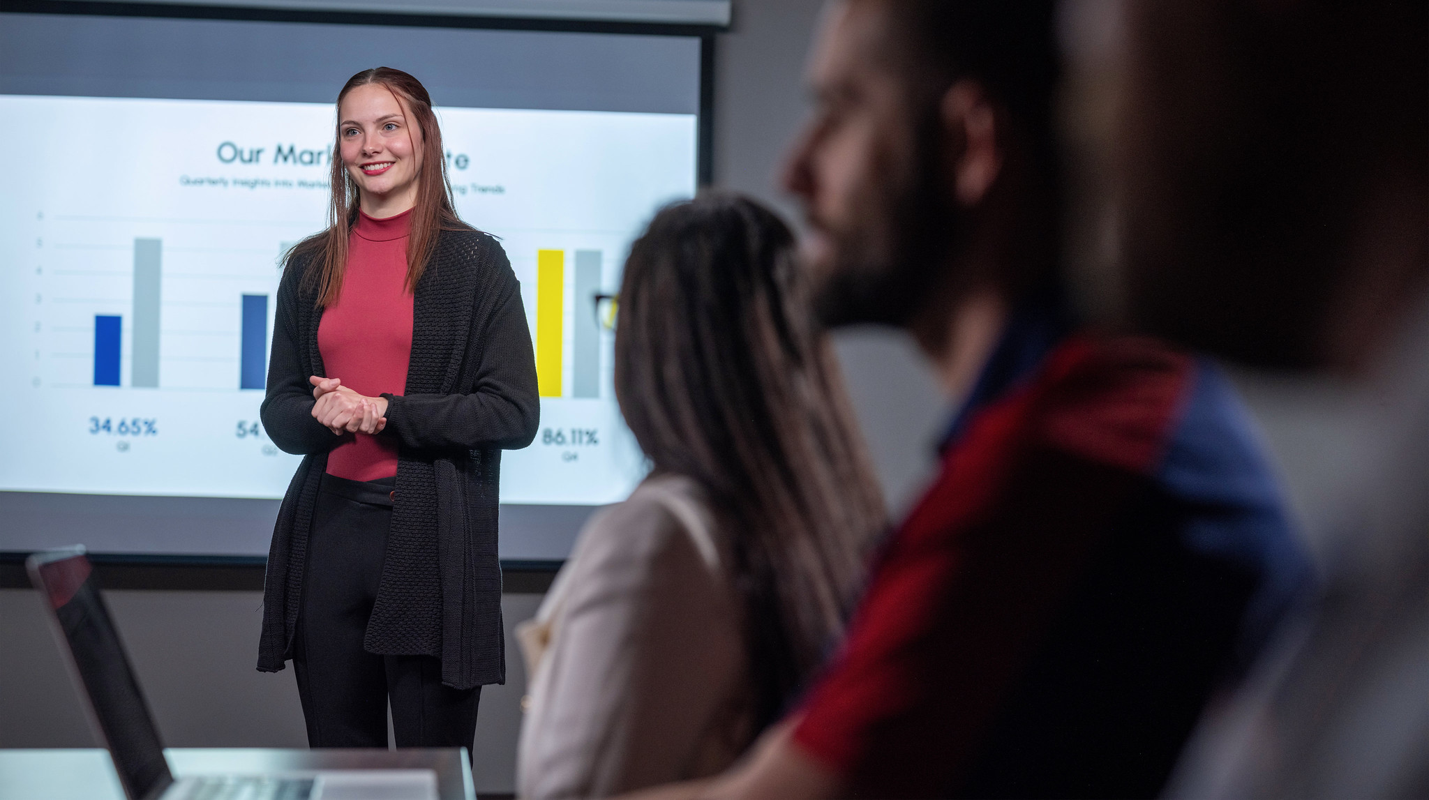 woman presents slides at a business meeting